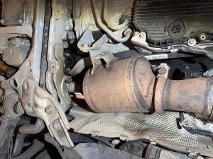 Diesel particulate filter fitted to the exhaust system underneath a Mercedes