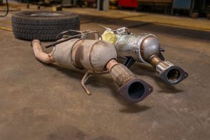 Used and replacement diesel particulate filter assemblies in a workshop